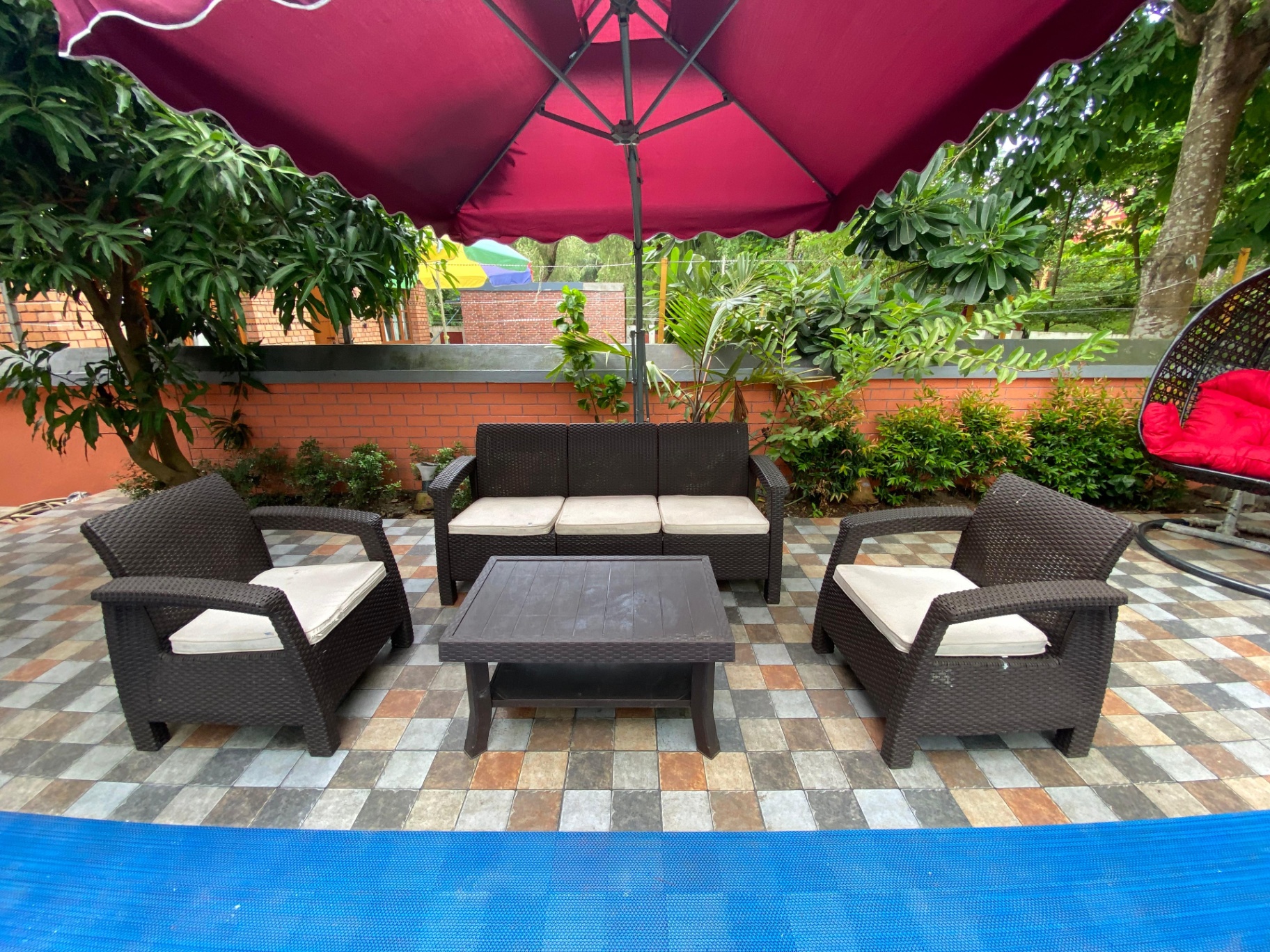 Poolside lounge under a crimson parasol