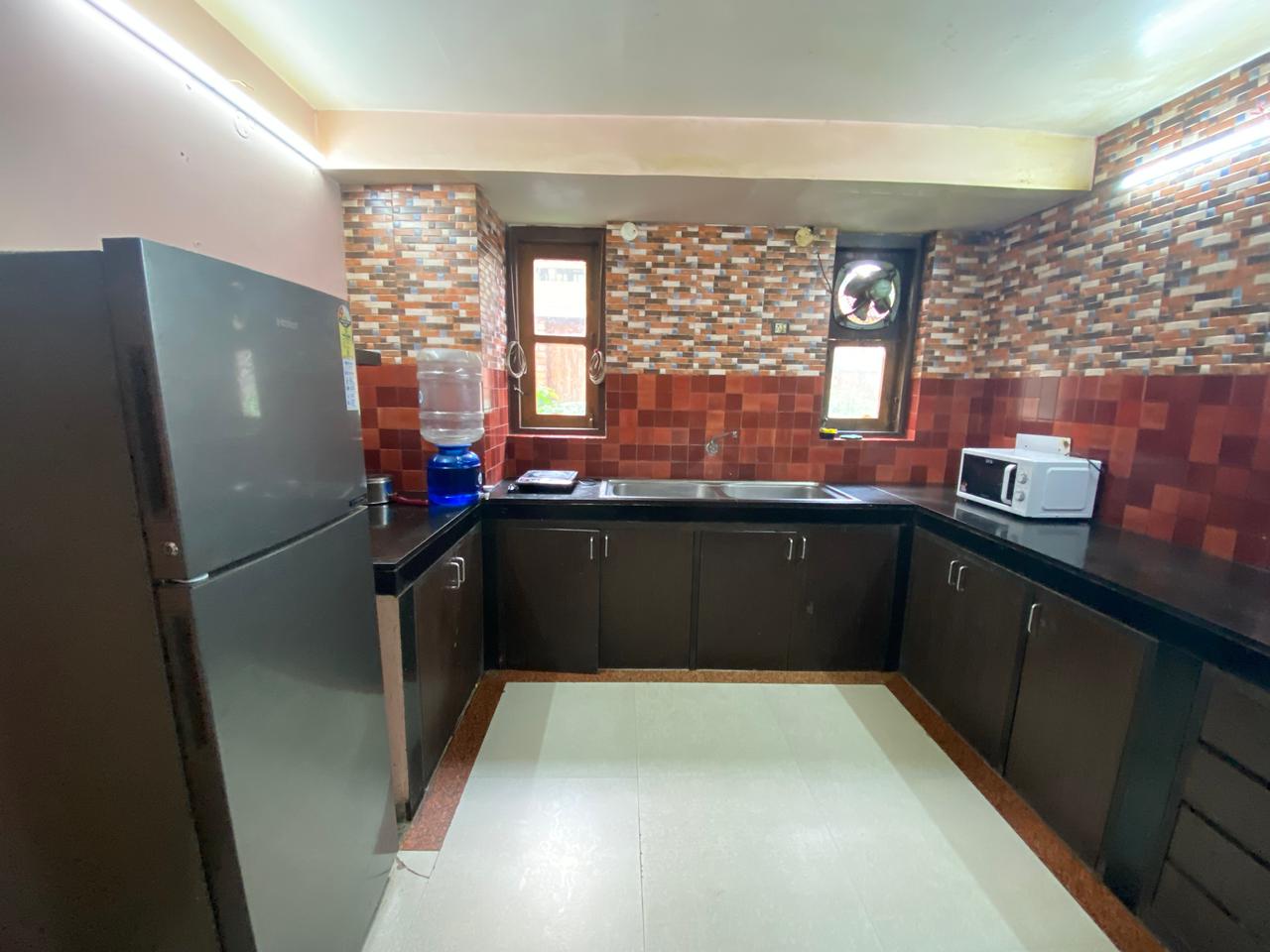 Kitchen with fridge, microwave and prep counter